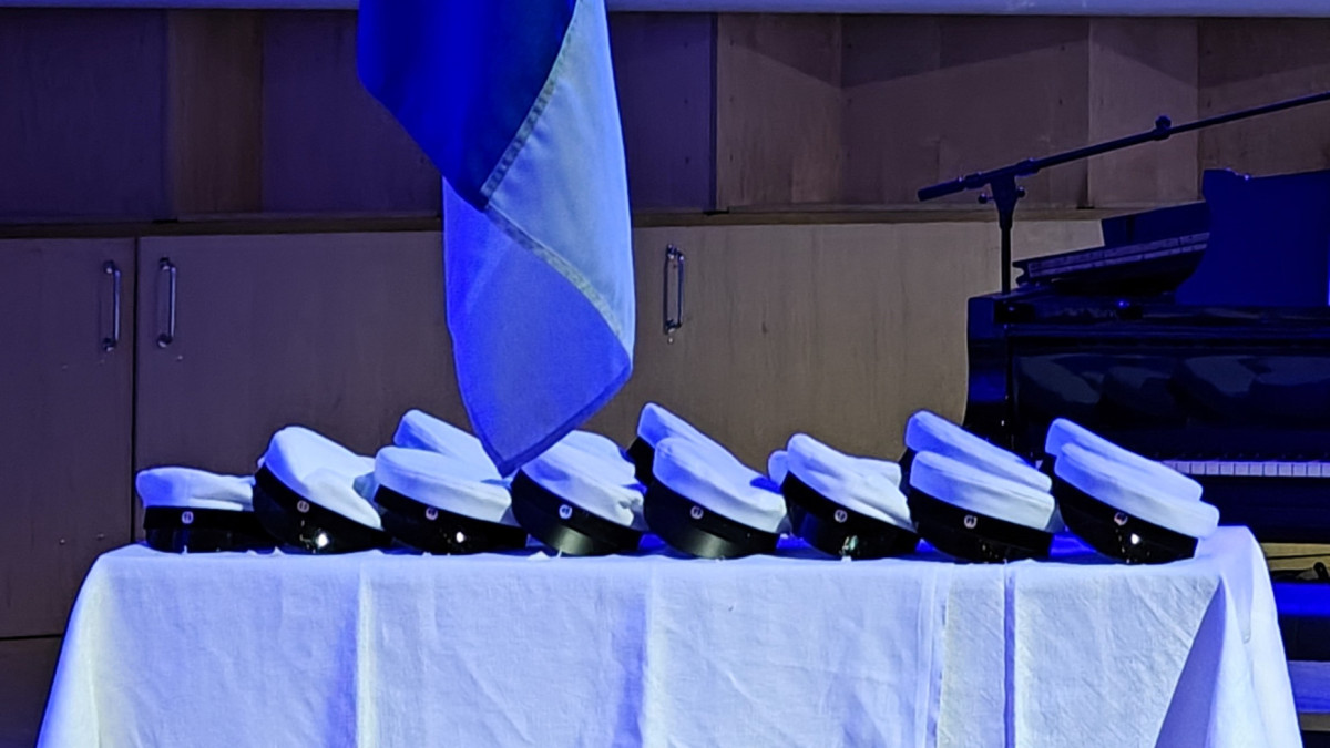 Ylioppilaslakkeja pöydällä.