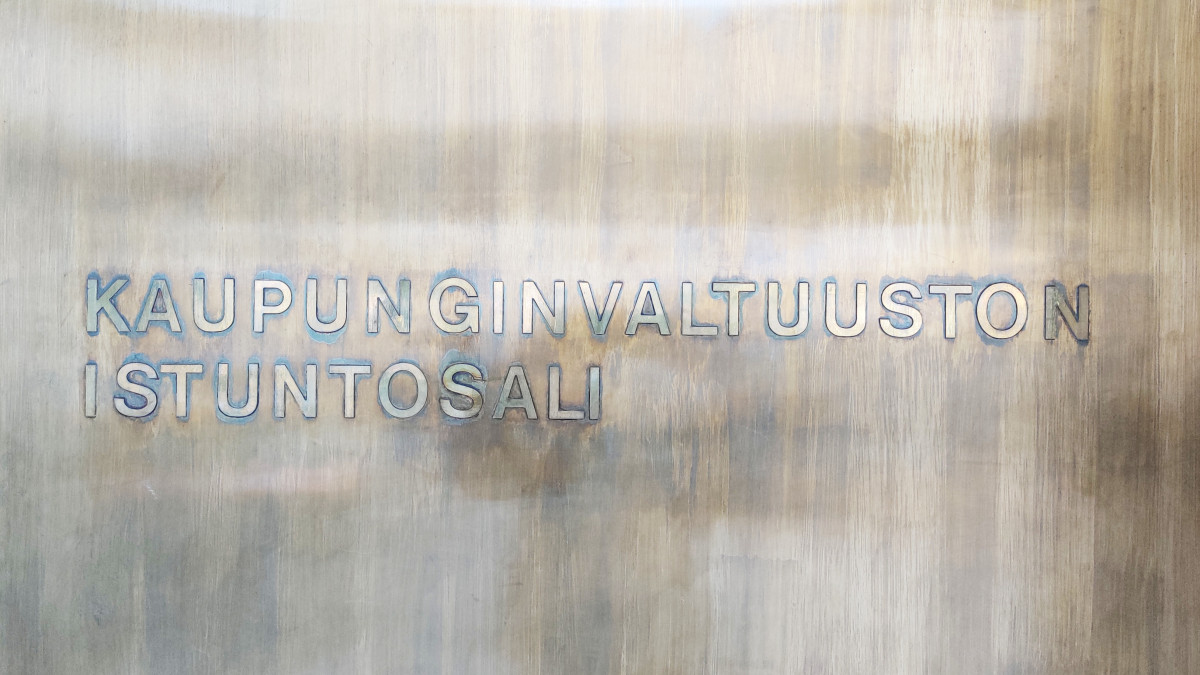 Valtuustosalin ovi. Ovessa lukee Kaupunginvaltuuston istuntosali.