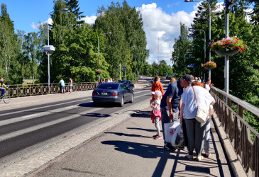Ihmisiä ja autoja Imatrankosken sillalla kesällä.